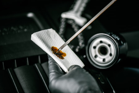 Technician checking the level and quality of engine oil. Car maintenance concept.の写真素材