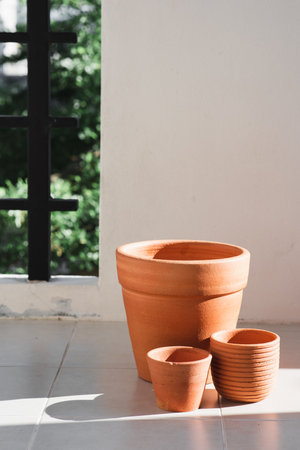 Empty orange clay flowerpot. Handmade pottery for plant.の写真素材