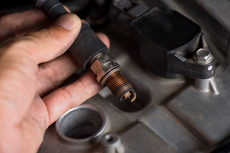 Spark plug replacement. Close up old spark plug, car maintenance concept.の写真素材