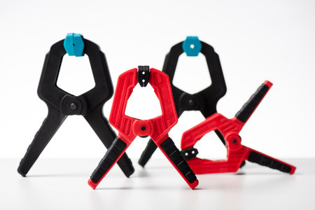 Plastic spring clamp isolated over white background. Equipment for woodworking, carpentry and other handiwork.の写真素材