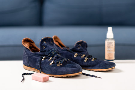 Cleaning the blue suede shoes. Shoe care concept.の写真素材