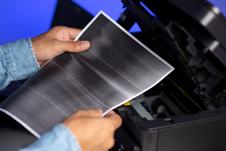 The man is repairing the laser printer.の写真素材