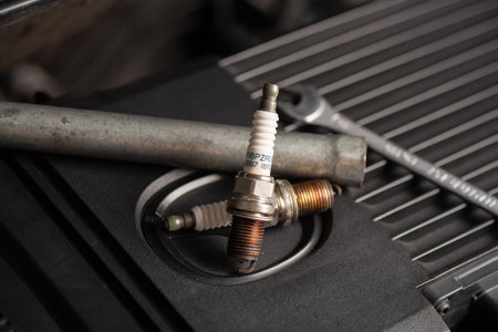 Spark plug replacement. Close up old spark plug, car maintenance concept.