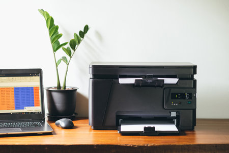 The multi-function laser printer on the desktop.