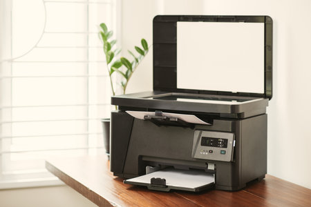 The multi-function laser printer on the desktop.の写真素材