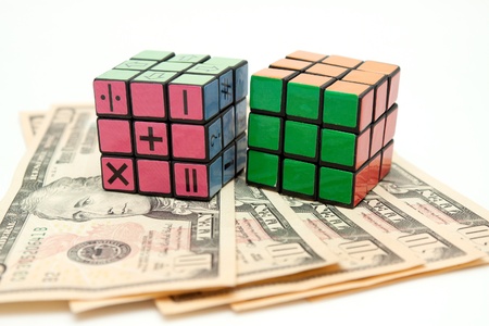 isolated cube puzzle and moneyのeditorial素材