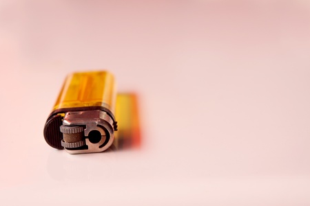 isolated lighter in pink backgroundの写真素材