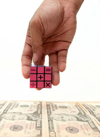 hand hold cube puzzle with banknote backgroundの写真素材