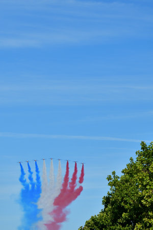 Paris, France. Bastille Day military parade. An aviation corps that flies while emitting smoke in the color of the French flag. July 14, 2022.のeditorial素材