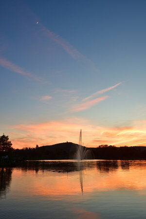 Metz, France. Plan d'Eau de Metz at magic hour with the moon. May 11, 2024.の写真素材