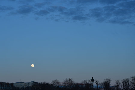 Full moon at dusk over the Tuileries Garden in Paris France evening sky landscapeの写真素材