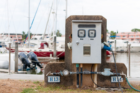 Power supply service at the marina  with sailboats and yacht behindの写真素材