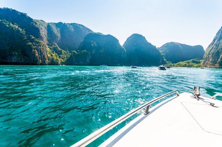 Baot heading to Maya bay in a sunshine day the beach with lush greenの写真素材