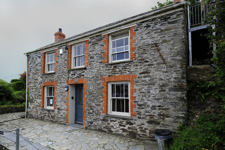 20 June 2018. Port Isaac. Cornwall. Large, stone built detached cottage, featured as the medical practice of Doc Martin in the UK TV series of the same name.のeditorial素材