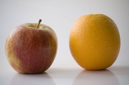 Apple and orange on the white background