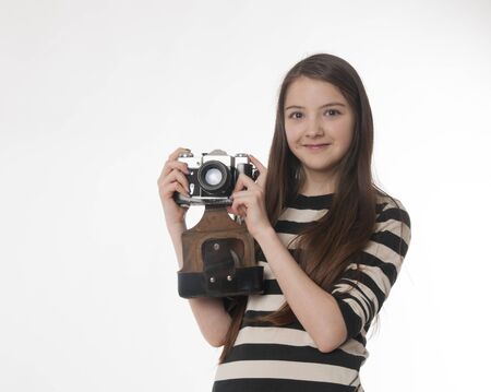 girl with old photokamera on white background