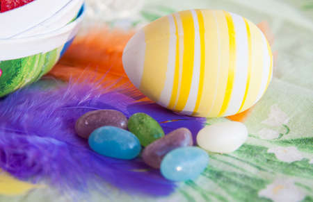 Easter sweets, eggs, flowers on a tableの写真素材