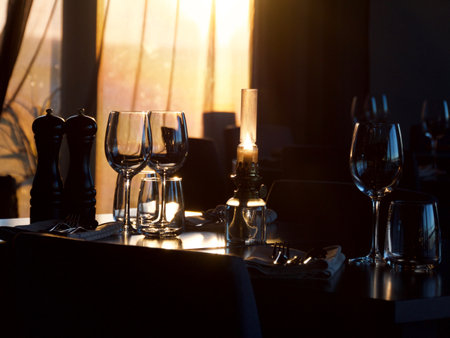 Loaf of fresh baked sliced baguette bread with butter on wooden slate serving board over dark brown background,copy space.の写真素材