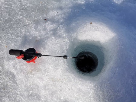 Ice fishing. Winter fishing, catching a fish in the Northの写真素材