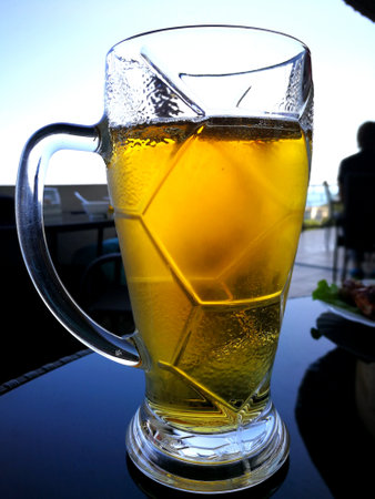 bubbles in the beer in the glass. the beer is poured into a beer glass and it flows in foam in a glassの写真素材