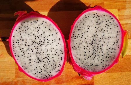 Dragon fruit on a wooden table in the sunlight. Exotic fruit.の写真素材