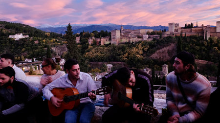 Tourists play guitar in Alhambra, Granada, Spain.の写真素材