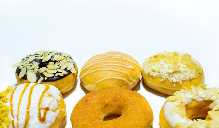 A selection of donuts with different toppingsの写真素材