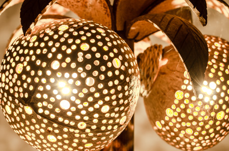 Bedside lamp made from perforated coconut shellの写真素材