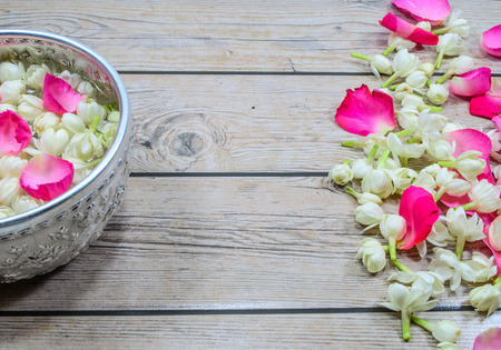 Floral garland with a bowl of flower petalsの写真素材