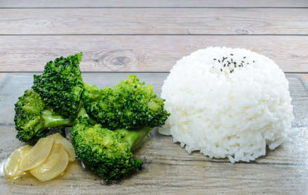Seasoned cooked broccoli with steamed white riceの写真素材