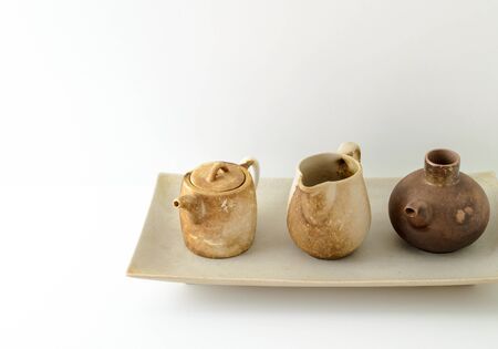 Old jugs used for ornamentsl purposes against whiteの写真素材