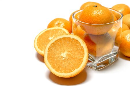 Whole oranges in glass and halved orangesの写真素材