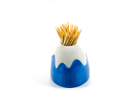 Toothpicks in a ceramic jar on white backgroundの写真素材