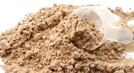 Whey protein powder with supplied scoop for measuringの写真素材