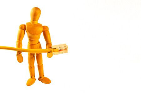 Wooden figurine holding a cableの写真素材