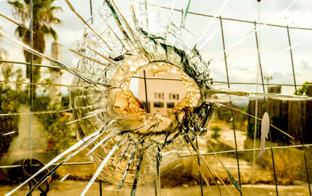 An old cinema billboard has the deep words of 'The End' painted onto a blank board, in a degraded parking lot.の写真素材