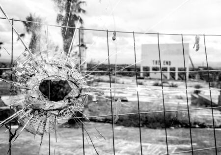 An old cinema billboard has the deep words of 'The End' painted onto a blank board, in a degraded parking lot.の写真素材