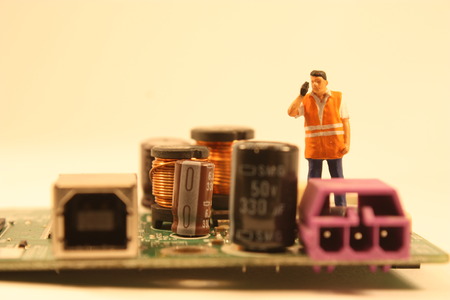 A team of skilled electrical engineers work together to repair broken components.の写真素材