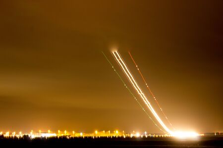 A view across a busy airport at night.の写真素材