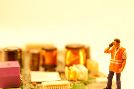 A team of skilled electrical engineers work together to repair broken components.の写真素材