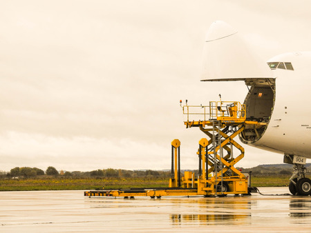 A huge Boeing 747 aircraft, one of the world's most beautiful aircraft with it's 2 deck airframe being loaded / offloaded with cargo.のeditorial素材