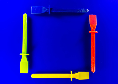Four plastic spatulas laid out, used for artwork or glue spreading.の写真素材