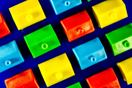 A blue background with plastic houses as the main focus.の写真素材