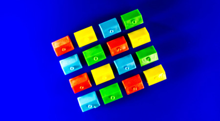 A blue background with plastic houses as the main focus.
