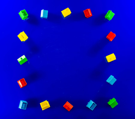 A blue background with plastic houses as the main focus.の写真素材