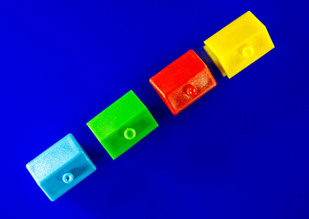 A blue background with plastic houses as the main focus.の写真素材