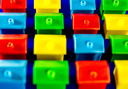 A blue background with plastic houses as the main focus.