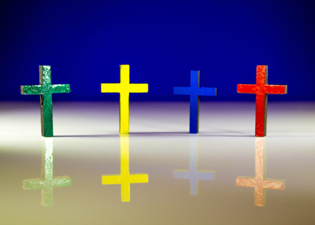 Christian crucifix crosses standing on a solid colour background.の写真素材