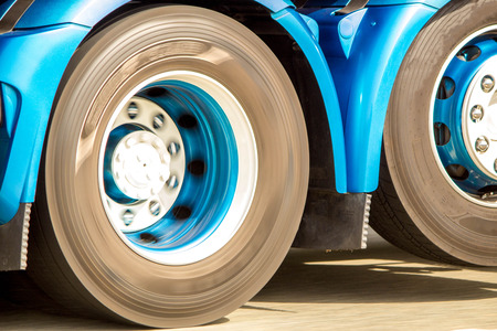 A closeup of wheels in motion from an articulated lorry, travelling along a UK motorway.の写真素材