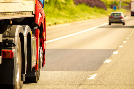 A closeup of wheels in motion from an articulated lorry, travelling along a UK motorway.の写真素材